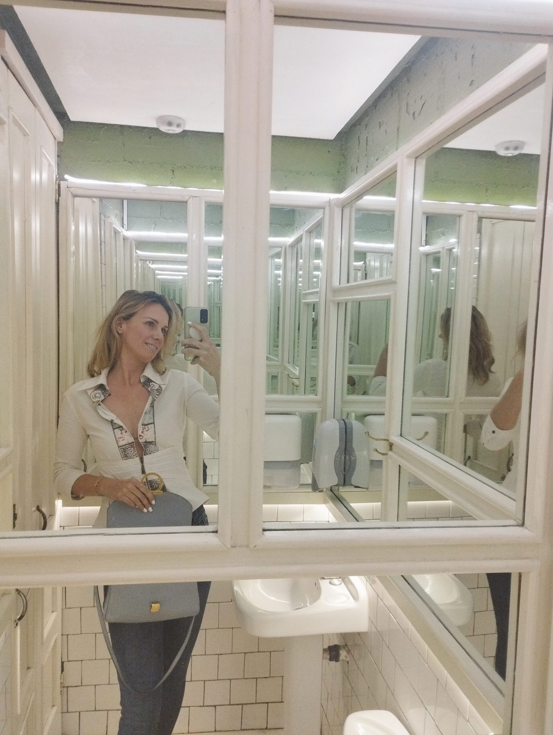 taking a selfie in room of mirrors