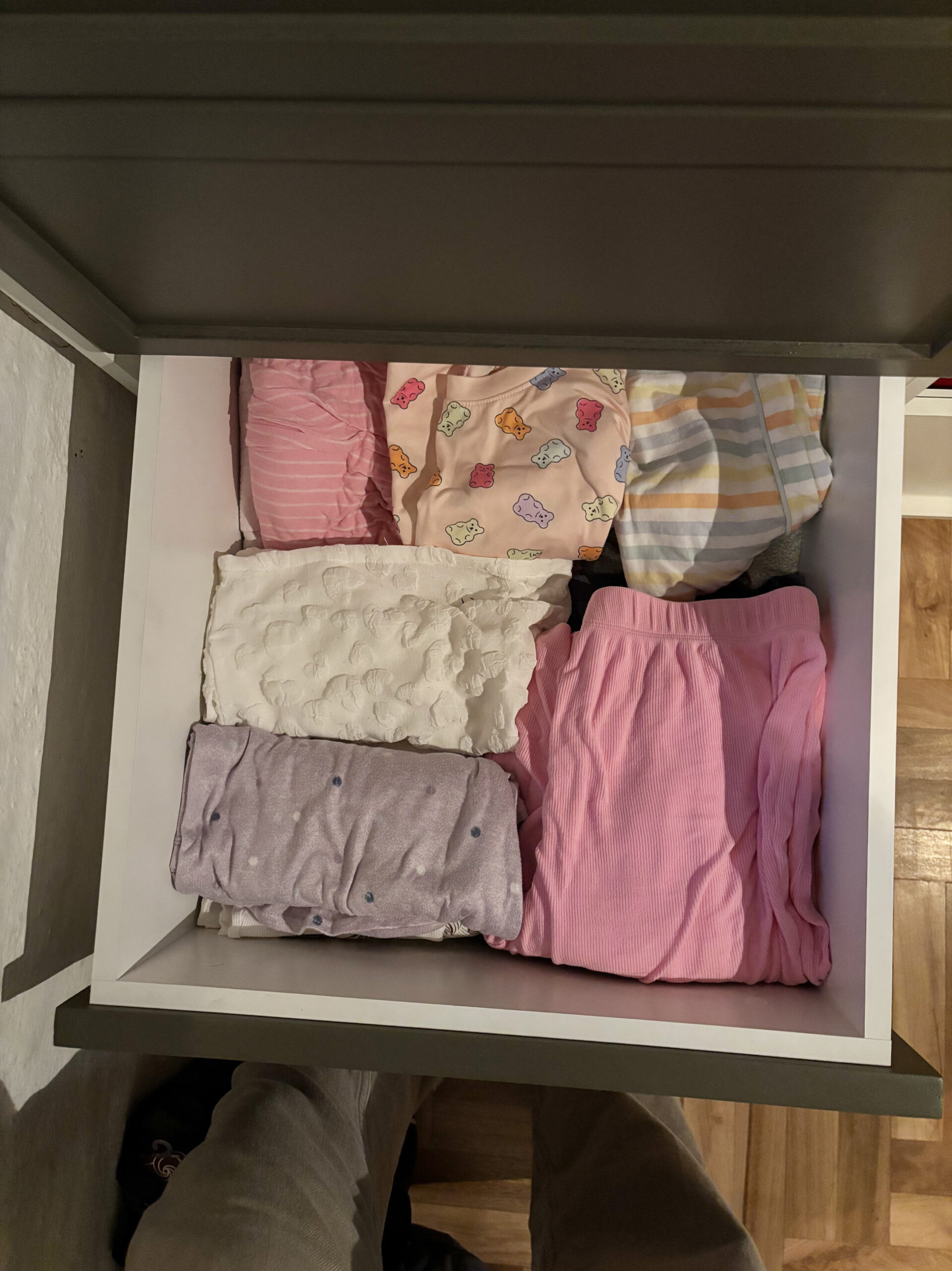 closet drawer filled with colorful pajamas