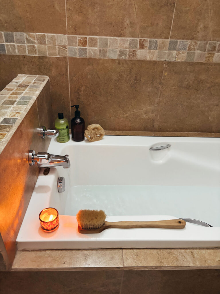 bathtub with candle and products on edge